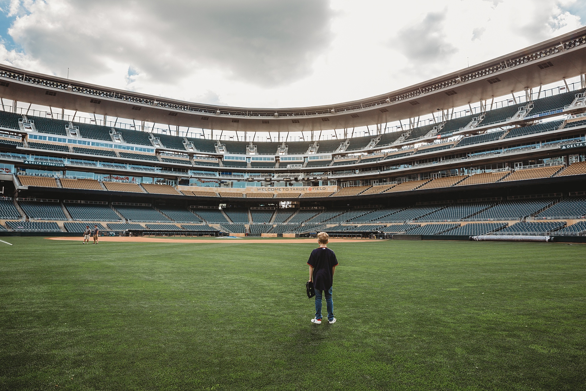 boy standing in the middle of Target field, Target Field Photography Session Minneapolis Child Photographer