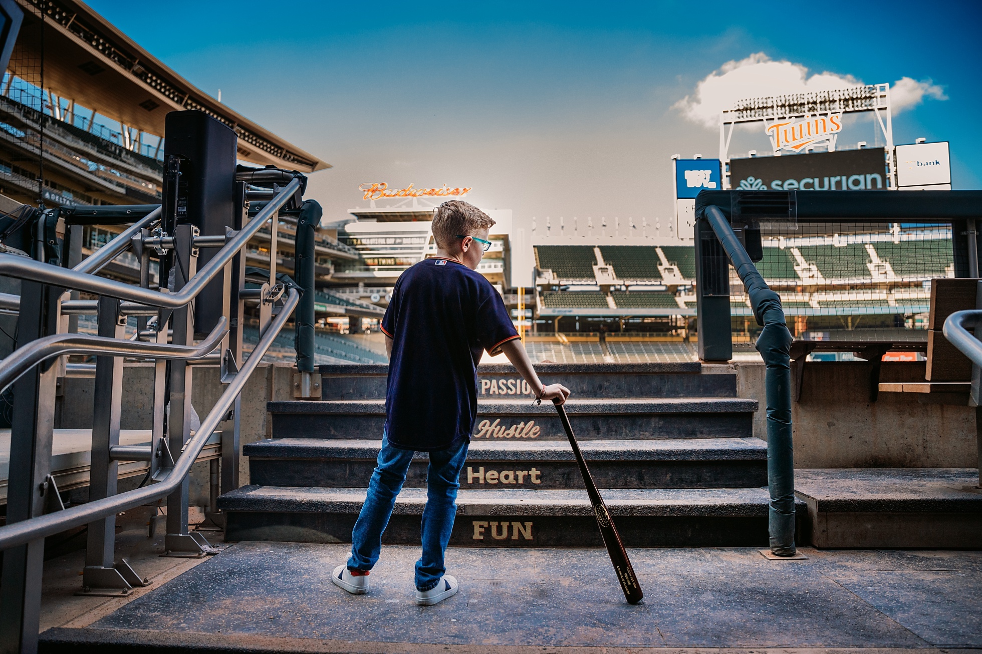 boy standing in Twins dugout at target field